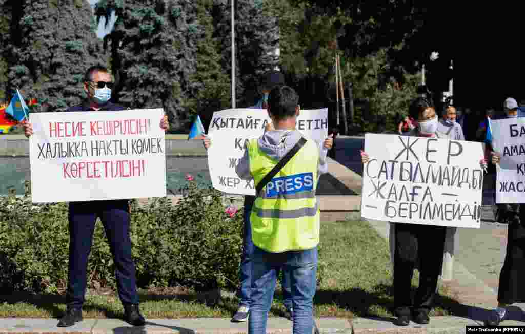 &quot;Пресса&quot; деген жазуы бар кеудеше киген журналист митингке қатысушыларды суретке түсіріе тұр. Алматы, 13 қыркүйек 2020 жыл.