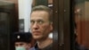 A still image taken from video footage shows Russian opposition leader Alexei Navalny, who is accused of flouting the terms of a suspended sentence for embezzlement, inside a defendant dock during the announcement of a court verdict in Moscow